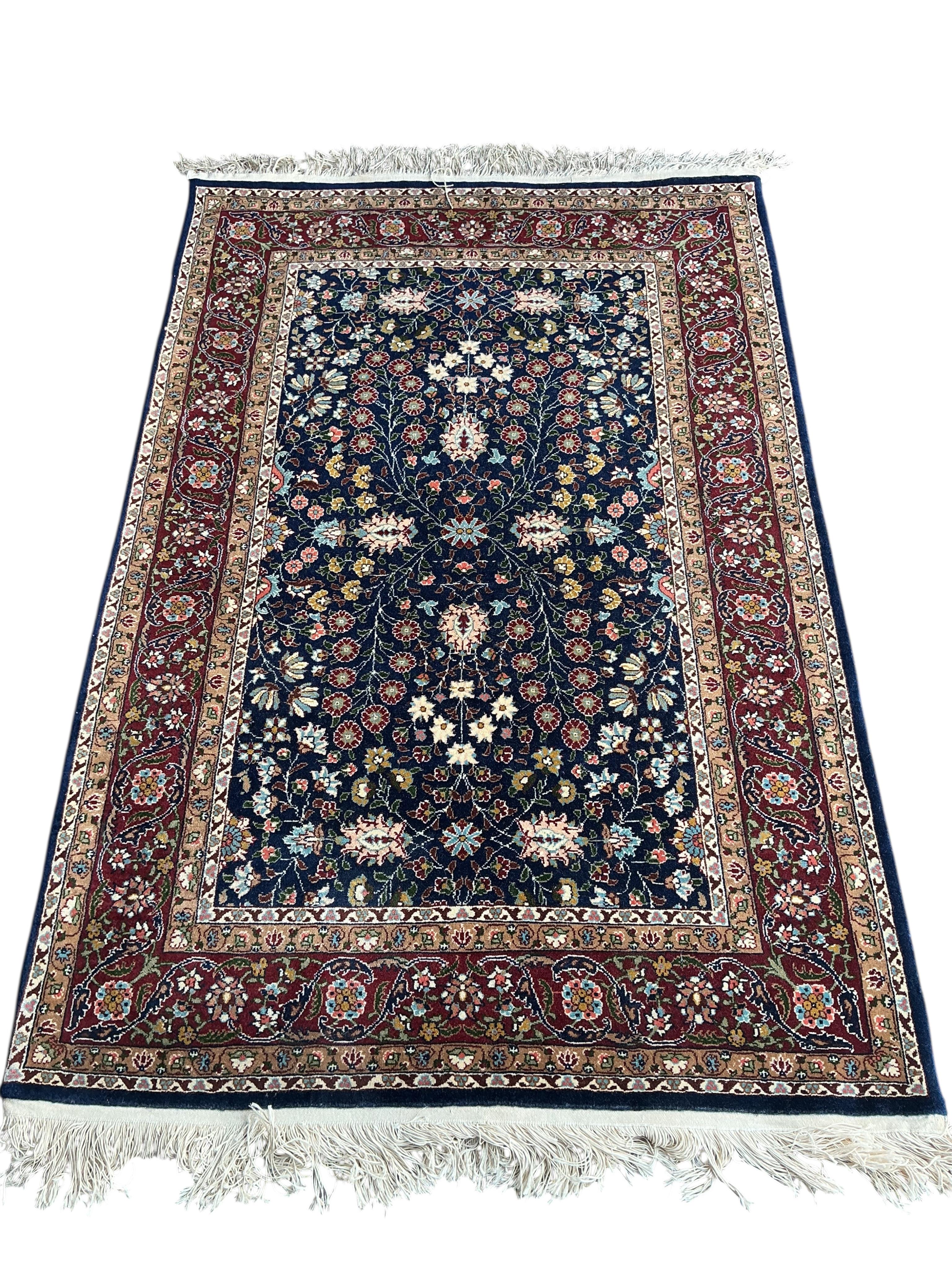 A Hereke Turkish blue ground rug, 150 x 100cm